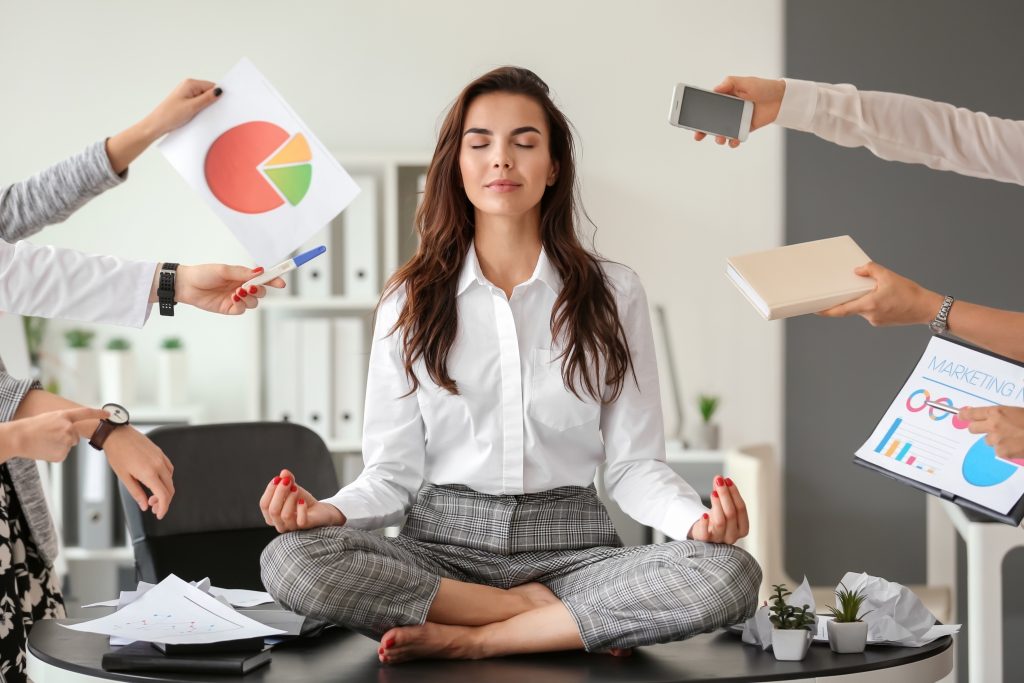 Woman controls emotions by meditating in office